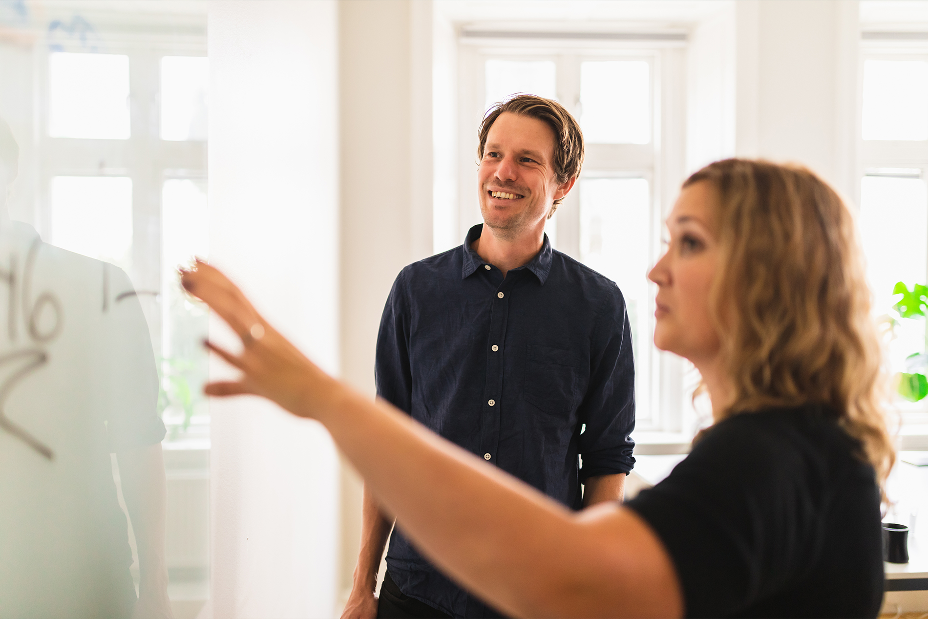 Man and woman meeting at whiteboard